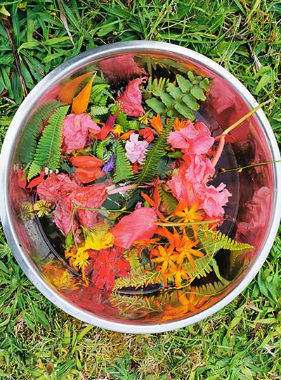 athena-naia-guzman-poole-flower-bath colourful flowers and leaves in a bowl